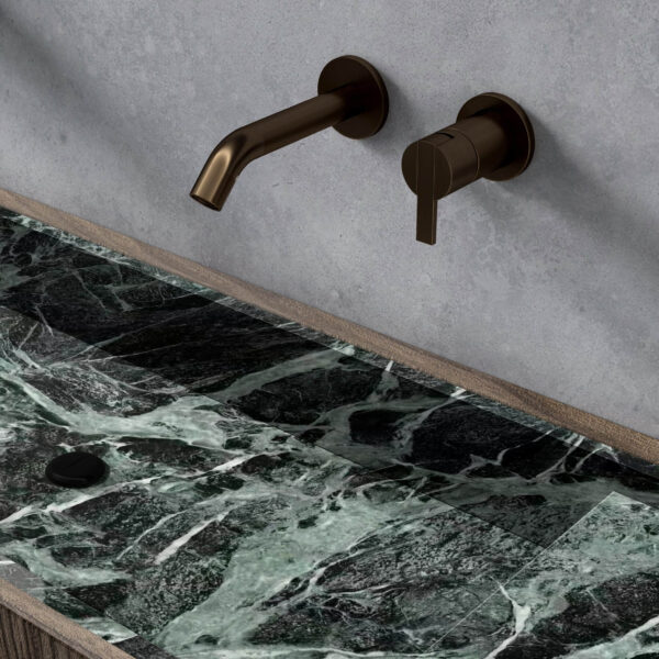 Emerald green sintered stone bench with bronze faucet.