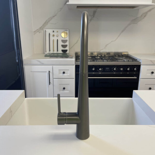 Modern kitchen with sleek faucet and marble backsplash.