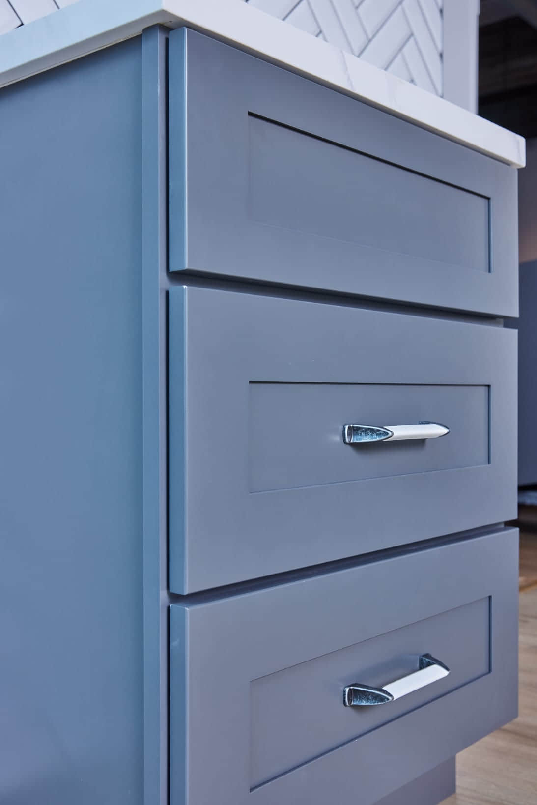 Blue kitchen cabinet with silver handle.
