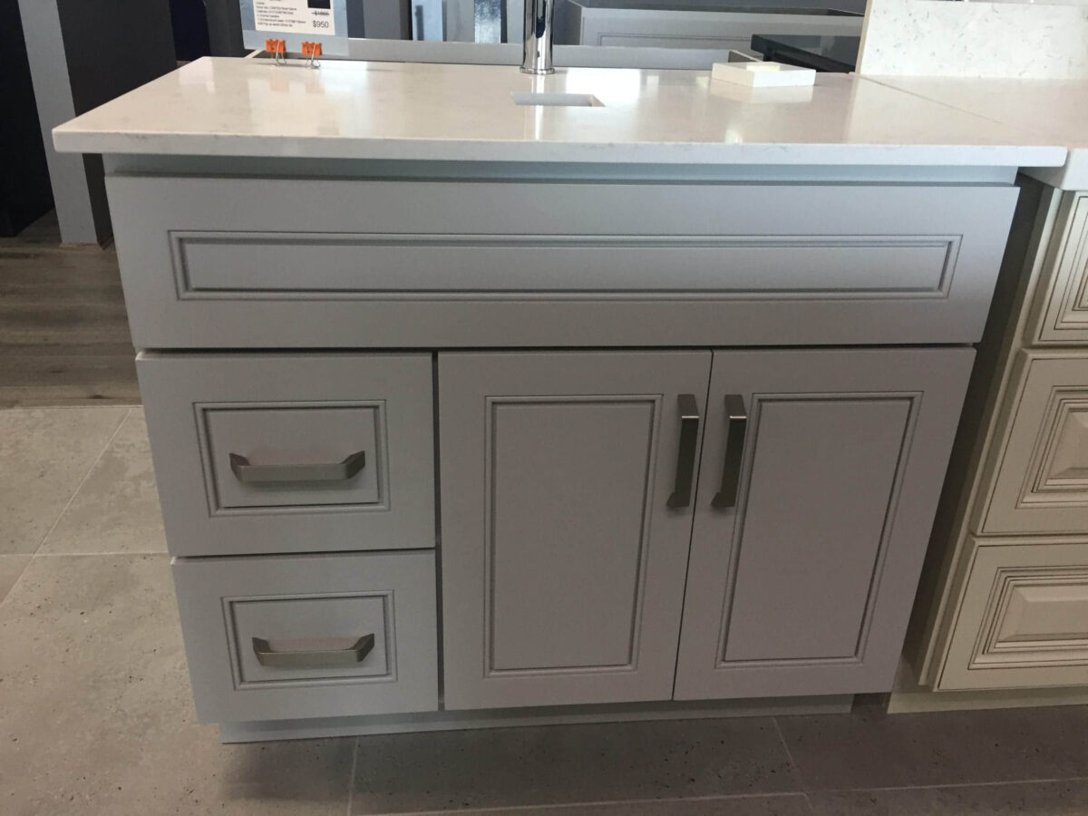 Modern kitchen cabinet with drawers and handles.