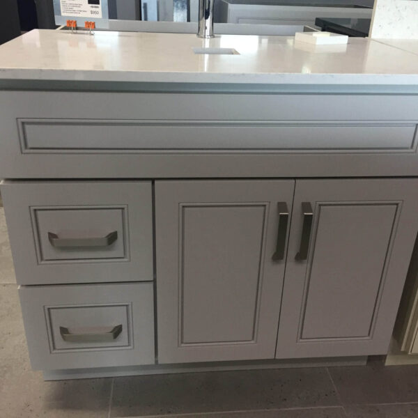 Modern kitchen cabinet with drawers and handles.