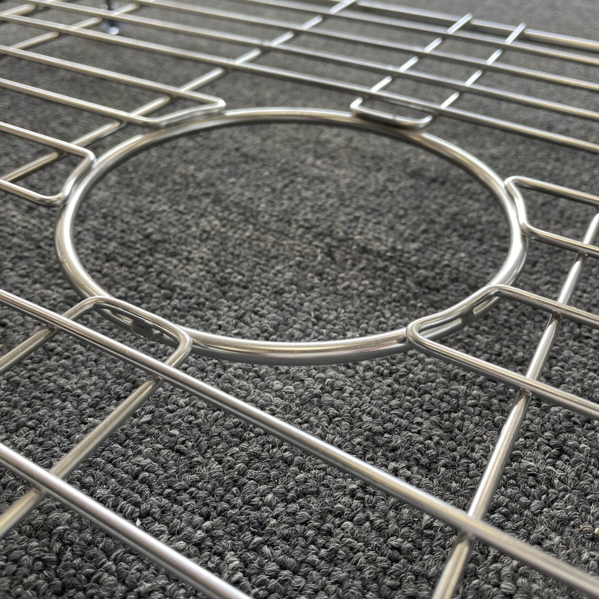 Butler sink protector on textured surface, close-up view.