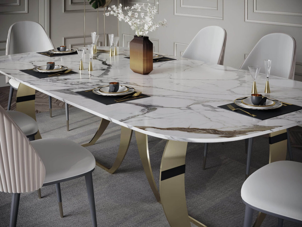 Elegant dining table with marble top and gold legs, set for a meal.