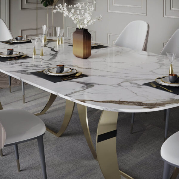 Elegant dining table with marble top and gold legs, set for a meal.