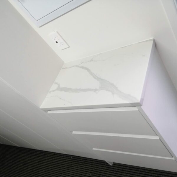 Calacatta Sky Quartz countertop on white cabinet in modern kitchen.