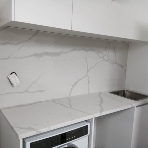 Modern kitchen with Calacatta Sky Quartz countertop and backsplash.