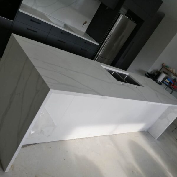 Calacatta Sky Quartz kitchen island in modern kitchen setting.