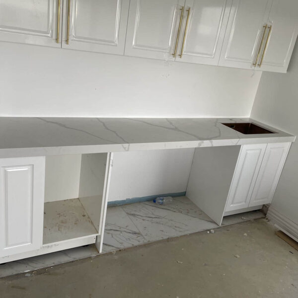 White kitchen cabinets with Calacatta Sky Quartz countertop.