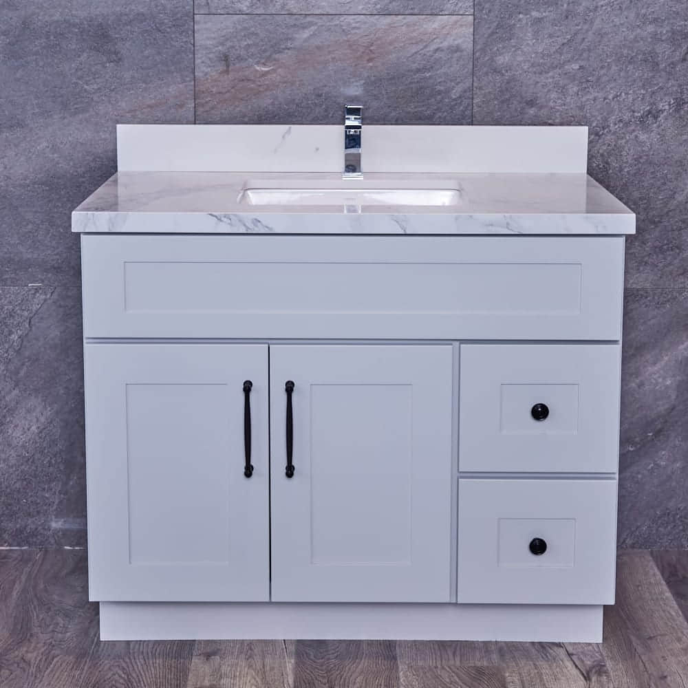 White bathroom vanity with marble countertop and modern faucet.